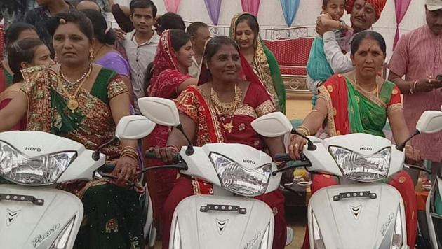 The small-scale mass wedding saw the mothers-in-law of the brides being showered with an assortment of gifts and put in the driver’s seat of a new two-wheeler each. (HT Photo) The small-scale mass wedding saw the mothers-in-law of the brides being showered with an assortment of gifts and put in the driver’s seat of a new two-wheeler each. (HT Photo)