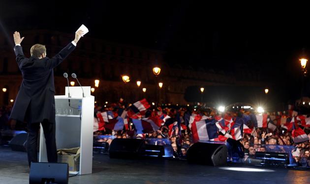 French President-elect Emmanuel Macron celebrates on stage at his victory rally near the Louvre museum, Sunday May 7, 2017 in Paris. Speaking to thousands of supporters from the Louvre Museum's courtyard, Macron said that France is facing an "immense task" to rebuild European unity, fix the economy and ensure security against extremist threats. (AP Photo) French President-elect Emmanuel Macron celebrates on stage at his victory rally near the Louvre museum, Sunday May 7, 2017 in Paris. Speaking to thousands of supporters from the Louvre Museum's courtyard, Macron said that France is facing an "immense task" to rebuild European unity, fix the economy and ensure security against extremist threats. (AP Photo)