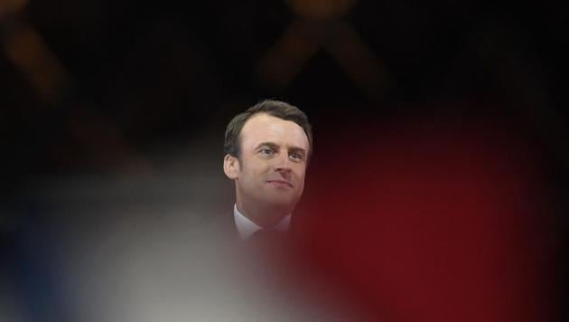 French president-elect Emmanuel Macron greets supporters before delivering a speech in front of the Pyramid at the Louvre Museum in Paris after the second round of the French presidential election. Emmanuel Macron was elected French president on May 7, 2017 in a resounding victory over far-right Front National (FN - National Front) rival after a deeply divisive campaign, initial estimates showed. (Eric Feferberg/AFP) French president-elect Emmanuel Macron greets supporters before delivering a speech in front of the Pyramid at the Louvre Museum in Paris after the second round of the French presidential election. Emmanuel Macron was elected French president on May 7, 2017 in a resounding victory over far-right Front National (FN - National Front) rival after a deeply divisive campaign, initial estimates showed. (Eric Feferberg/AFP)