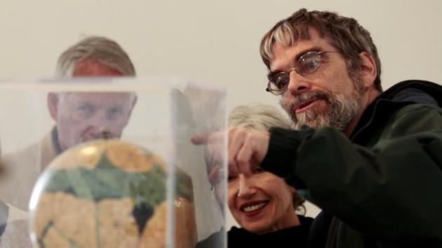 Jesuit Brother Guy Consolmagno, a Jesuit astronomer at the Vatican's Observatory, right, shows to visitors the Globe of planet Mars from the collection of the Specola Vaticana. (AP File Photo) Jesuit Brother Guy Consolmagno, a Jesuit astronomer at the Vatican's Observatory, right, shows to visitors the Globe of planet Mars from the collection of the Specola Vaticana. (AP File Photo)