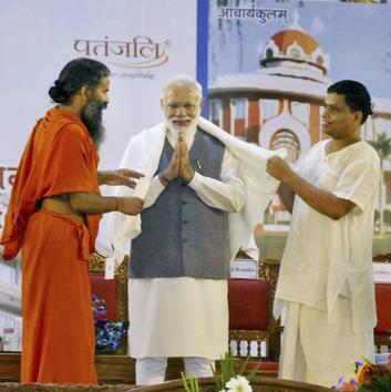 Prime Minister Narendra Modi welcomed by Baba Ramdev and his aide Balkrishan during the inauguration of the Patanjali Research Institute in Haridwar in Uttarakhand. (PTI) Prime Minister Narendra Modi welcomed by Baba Ramdev and his aide Balkrishan during the inauguration of the Patanjali Research Institute in Haridwar in Uttarakhand. (PTI)