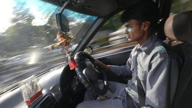Soft spoken and working back to back long hours driving a taxi on Delhi’s roads, Debendra Kapri sleeps in his car waiting for his turn to pick up passengers from the airport. (Ravi Choudhary/HT PHOTO)
