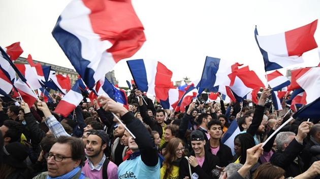 Supporters of the French presidential election candidate wave French national flags, after Emmanuel Macron emerged victorious in the presidential elections. Cutting state spending, easing labour laws, boosting education in deprived areas are few of the agendas proposed by Macron. (Eric Feferberg/AFP) Supporters of the French presidential election candidate wave French national flags, after Emmanuel Macron emerged victorious in the presidential elections. Cutting state spending, easing labour laws, boosting education in deprived areas are few of the agendas proposed by Macron. (Eric Feferberg/AFP)