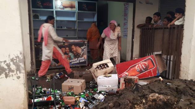 The case was registered after high drama was witnessed outside a liquor vend at Lohgarh in Zirakpur on Tuesday evening after women protested against the setting up of a liquor vend in the residential area and completely damaged it.(HT Photo)