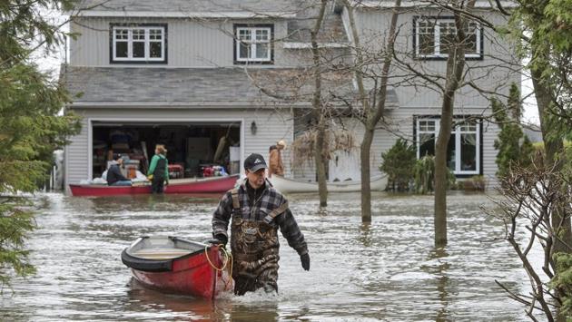 Residents use canoes to access their home in Deux-Montagnes, Quebec. (Ryan Remiorz/The Canadian Press/AP)