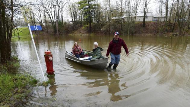 Pam Komm, 81, is helped by her daughter Sandra and son Wayne as they rescue her from her flooded home in Quyon. In British Columbia, on the opposite side of the country, the same combination of rain and snowmelt has caused flooding and mudslides that left at least two people missing, including the fire chief of the village of Cache Creek who had been out checking water levels. (PTI/AP)