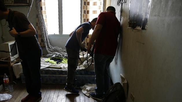 In this April 20, 2017, photo, investigators check a room in the home of suspected child webcam cybersex operator, David Timothy Deakin, from Peoria, Ill., during a raid in Mabalacat, Philippines. (AP Photo) In this April 20, 2017, photo, investigators check a room in the home of suspected child webcam cybersex operator, David Timothy Deakin, from Peoria, Ill., during a raid in Mabalacat, Philippines. (AP Photo)
