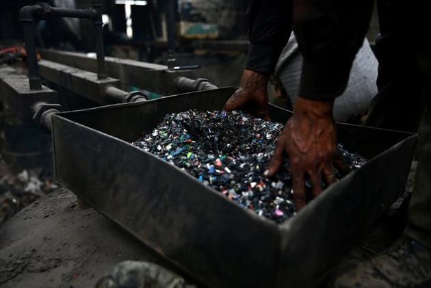 A man works on breaking -down pieces of plastic at a workshop. (Bassam Khabieh / Reuters) A man works on breaking -down pieces of plastic at a workshop. (Bassam Khabieh / Reuters)