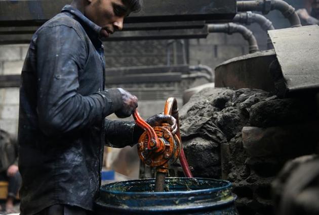 Khodor, 20, extracts fuel from plastic in a workshop .As the siege intensified, severe fuel shortages began to hamper agriculture, transport and other activities. (Bassam Khabieh / Reuters) Khodor, 20, extracts fuel from plastic in a workshop .As the siege intensified, severe fuel shortages began to hamper agriculture, transport and other activities. (Bassam Khabieh / Reuters)