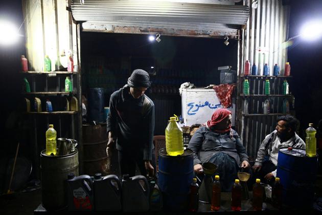 A young man fills a container with locally-made fuel. The fuels are then sold to customers, including bakeries, farmers who need fuel to power water pumps and consumers for use in cars and motorcycles. (Bassam Khabieh / Reuters) A young man fills a container with locally-made fuel. The fuels are then sold to customers, including bakeries, farmers who need fuel to power water pumps and consumers for use in cars and motorcycles. (Bassam Khabieh / Reuters)
