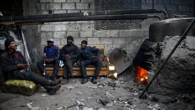 Abu Fahad (2nd R) rests with colleagues inside a workshop in the rebel-held besieged Douma neighbourhood of Damascus, Syria. The workshop uses plastic from bottles and other waste materials to produce liquid and gas fuels.The liquid is refined into gasoline, diesel and benzene fuels which are sold for domestic and commercial use. Reeling under the constant assaults by the regime and IS, they have now resorted to making their own fuel. (Bassam Khabieh / Reuters) Abu Fahad (2nd R) rests with colleagues inside a workshop in the rebel-held besieged Douma neighbourhood of Damascus, Syria. The workshop uses plastic from bottles and other waste materials to produce liquid and gas fuels.The liquid is refined into gasoline, diesel and benzene fuels which are sold for domestic and commercial use. Reeling under the constant assaults by the regime and IS, they have now resorted to making their own fuel. (Bassam Khabieh / Reuters)