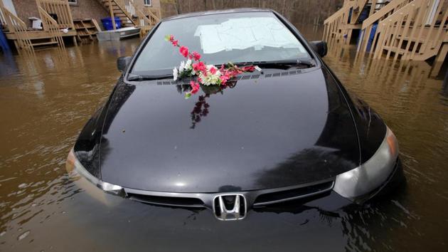 An abandoned car with a sign reading 'R.I.P.' in the windshield is seen in a flooded residential area in Gatineau. After days of fighting an exhausting battle to hold back the waters, often in vain, despair has started to set in. (Chris Wattie/REUTERS)