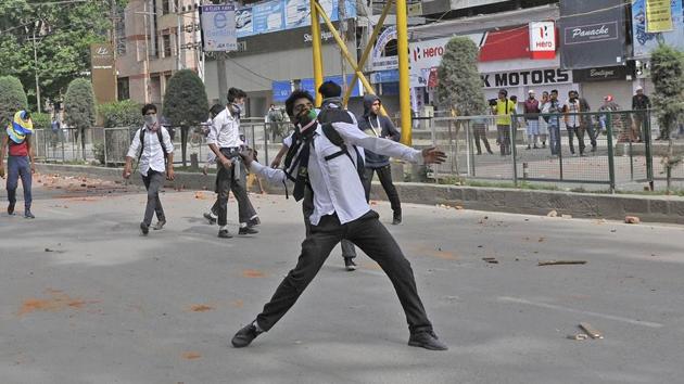 A Kashmiri student throws a stone during clashes with police in Srinagar’s Lal Chowk on Tuesday. (Waseem Andrabi/HT Photo) A Kashmiri student throws a stone during clashes with police in Srinagar’s Lal Chowk on Tuesday. (Waseem Andrabi/HT Photo)
