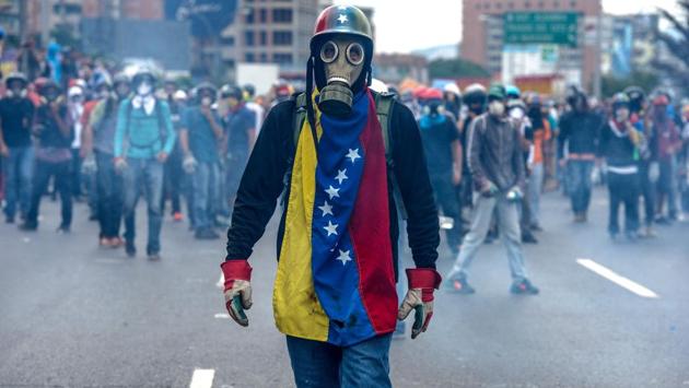 Opposition activists protest against President Nicolas Maduro, in Caracas. (FEDERICO PARRA / AFP)