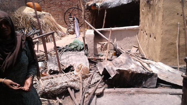 A Dalit woman in Shabbirpur village in Saharanpur stands among the ruins of her house allegedly destroyed by a Thakur mob on May 5.(Gulam Jeelani/HT PHOTO)