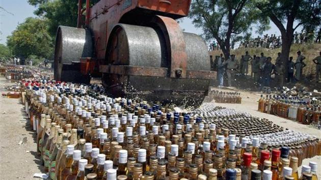 A roller crushes liquor bottles. (REUTERS file photo) A roller crushes liquor bottles. (REUTERS file photo)