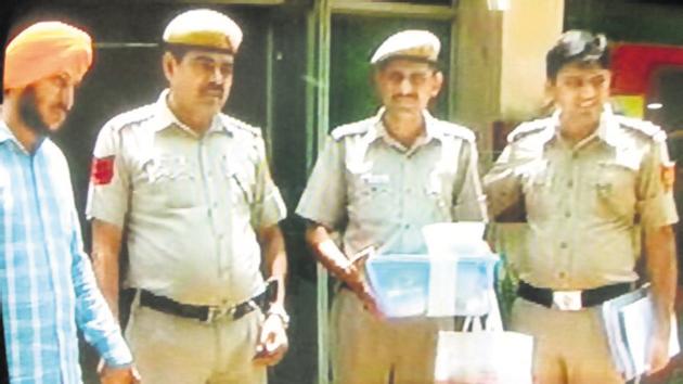 Gurvinder Singh (left) in police custody.(Handout)