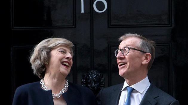(FILES) This file photo taken on July 13, 2016 shows Britain's new Prime Minister Theresa May (L) and her husband Philip John May posing for a photograph outside the door of 10 Downing Street in central London, on the day that May took office following the formal resignation of David Cameron. (AFP) (FILES) This file photo taken on July 13, 2016 shows Britain's new Prime Minister Theresa May (L) and her husband Philip John May posing for a photograph outside the door of 10 Downing Street in central London, on the day that May took office following the formal resignation of David Cameron. (AFP)