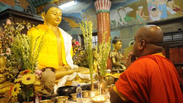A monk offers prayers at  Mahabodhi Society temple  in Kolkata. (Samir Jana/HT PHOTO) 