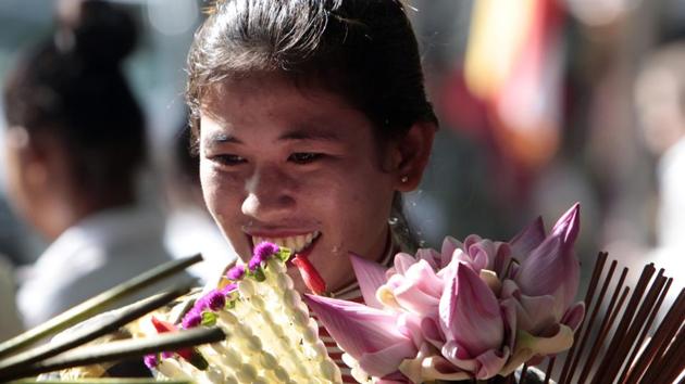 A Cambodian vendor holds flowers during the Buddhist Visak Bochea. (Heng Sinith/AP)