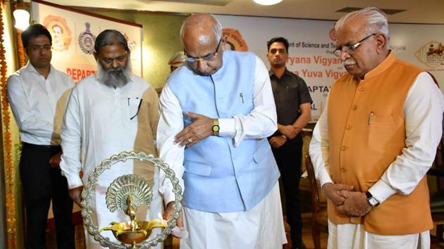 Haryana governor Kaptan Singh Solanki along with Haryana chief minister Manohar Lal Khattar and Science and Technology Minister and Haryana cabinet minister Anil Vij lighting the traditional lamp to inaugurate function to felicitate 11 eminent scientists of Haryana at Haryana Raj Bhavan in Chandigarh on Wednesday.(HT Photo)