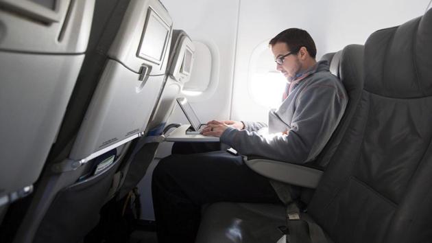 A man uses his laptop on a flight out of John F Kennedy International Airport in New York.(REUTERS File) A man uses his laptop on a flight out of John F Kennedy International Airport in New York.(REUTERS File)