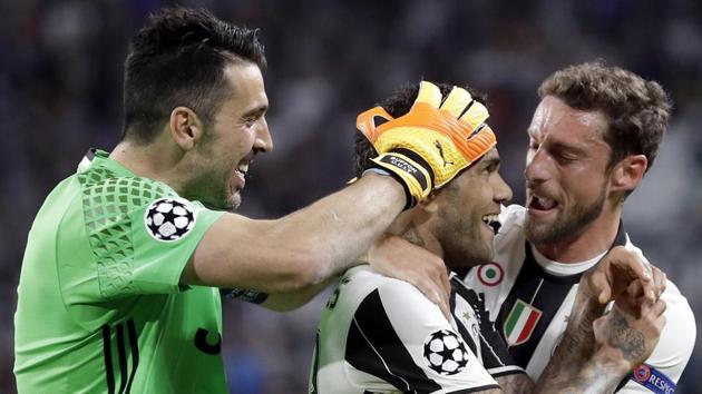 Juventus' scorer Dani Alves, center, and his teammates Claudio Marchisio, right, and Gianluigi Buffon, left, celebrate their side's 2nd goal during the Champions League semi final second leg against Monaco. Get highlights of Juventus vs Monaco here(AP)
