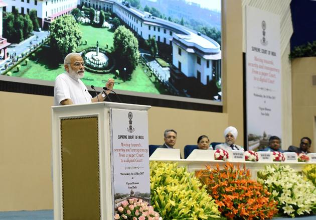 Prime Minister Narendra Modi addresses the event marking introduction of digital filing as a step towards a paperless Supreme Court in New Delhi on Wednesday.