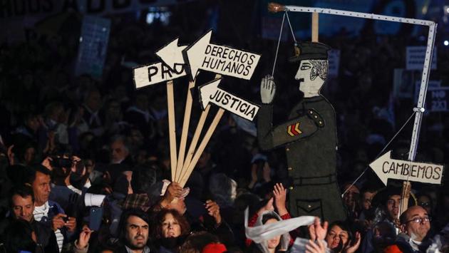 Demonstrators holding signs reading "human rights", "justice" and "let's change!" during the march. Demonstrators marched to the Plaza de Mayo square in front of the presidential palace carrying banners with pictures of those who were forcibly disappeared in a government-sponsored crackdown on leftist dissidents during Argentina’s “dirty war.” (Emiliano Lasalvia/AFP)