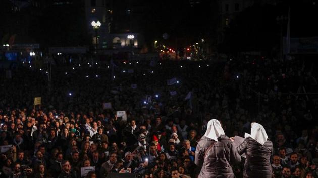 Many wore white headscarves that have become a symbol of the Mothers and Grandmothers of Plaza de Mayo human rights groups. (Emiliano Lasalvia/AFP)