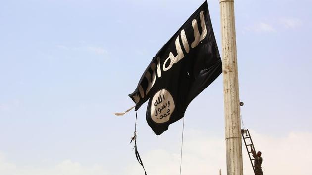 This file photo taken on April 30, 2017 shows a member of the US-backed Syrian Democratic Forces (SDF), made up of an alliance of Arab and Kurdish fighters, removing an Islamic State group flag in the town of Tabqa, about 55 kilometres (35 miles) west of Raqa city, as they advance in their battle for the group's de facto capital. (AFP) This file photo taken on April 30, 2017 shows a member of the US-backed Syrian Democratic Forces (SDF), made up of an alliance of Arab and Kurdish fighters, removing an Islamic State group flag in the town of Tabqa, about 55 kilometres (35 miles) west of Raqa city, as they advance in their battle for the group's de facto capital. (AFP)