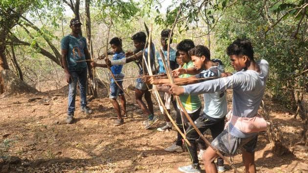 Tribals aiming on wild animals with their traditional weapons during "Sendra " ( annual hunting festival of trbals) at Dalma forest in Jamshedpur(Manoj Kumar/ HT Photo)