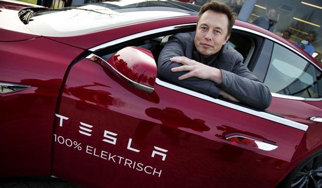 Elon Musk, co-founder and CEO of Tesla, poses with a model of the brand during a visit to Amsterdam.(EPA) Elon Musk, co-founder and CEO of Tesla, poses with a model of the brand during a visit to Amsterdam.(EPA)