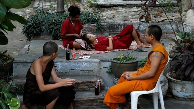 Nat (2nd L) combs a friend's hair during their stay at Wat Thamkrabok monastery in Saraburi province. (Jorge Silva / Reuters) Nat (2nd L) combs a friend's hair during their stay at Wat Thamkrabok monastery in Saraburi province. (Jorge Silva / Reuters)
