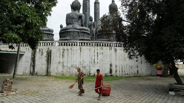 A Buddhist monk and a patient sweep the yard. (Jorge Silva / Reuters) A Buddhist monk and a patient sweep the yard. (Jorge Silva / Reuters)