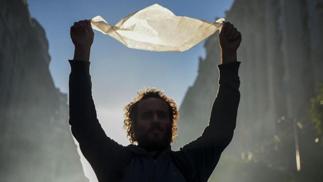 A demonstrator carrying a white headscarf as he represents the Madres de Plaza de Mayo human rights group march to the Plaza de Mayo square in downtown Buenos Aires.Thousands of Argentines of all ages and opposing political parties joined to protest a Supreme Court ruling that many feared would lead to the release of convicted human rights criminals. (Eitan Abramovich/AFP)