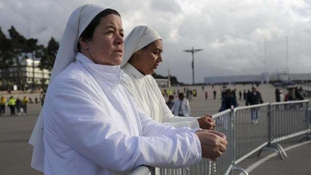 Two nuns attend a mass at the Chapel of the Apparitions in the Fatima Sanctuary. (Paulo Duarte/AP)