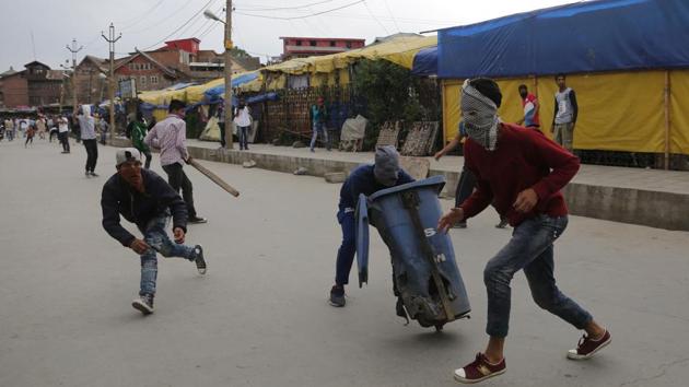 Masked Kashmiri protesters run for cover as Indian government forces fire pellets in Srinagar, Kashmir, Friday, May 12, 2017. (AP Photo) Masked Kashmiri protesters run for cover as Indian government forces fire pellets in Srinagar, Kashmir, Friday, May 12, 2017. (AP Photo)
