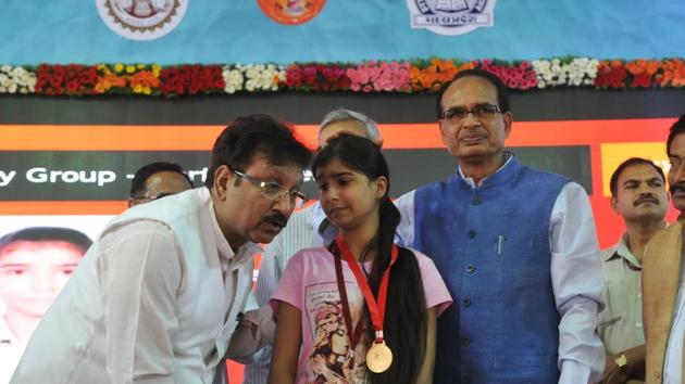School education minister Kunwar Vijay Shah listening to a topper during felicitation function of the meritorious students of the MP state board examinations in Bhopal on Friday. (Mujeeb Faruqui/HT Photo) School education minister Kunwar Vijay Shah listening to a topper during felicitation function of the meritorious students of the MP state board examinations in Bhopal on Friday. (Mujeeb Faruqui/HT Photo)