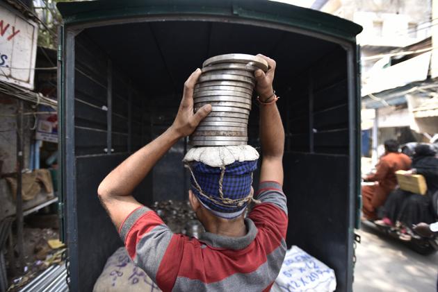 Insurance cover and employer liability are not things that these workers enjoy. Chawri Bazar is specialized wholesale market of brass, copper and paper products. (Burhaan Kinu/HT PHOTO)