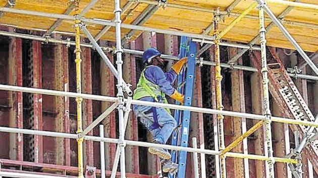 A labourer climbs a ladder as he works at the construction site of a building in Riyadh, Saudi Arabia. (File photo, representative photo)(Reuters)