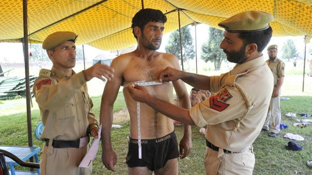 Police officers measure the chest of a Kashmiri youth during the recruitment rally. (Waseem Andrabi/ht photo) Police officers measure the chest of a Kashmiri youth during the recruitment rally. (Waseem Andrabi/ht photo)