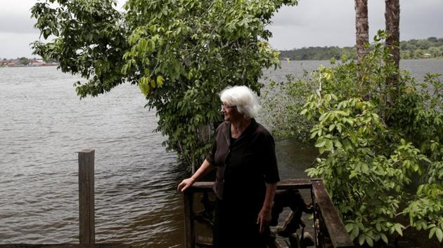 Valeria Leal stands on the deck of the house where she lives on an island in the Oiapoque River.Geologists have predicted the area may contain as many as 14 billion barrels of petroleum reserves. (Ricardo Moraes/REUTERS)