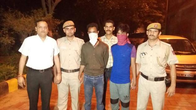 The alleged killer and his associate with police. The alleged killer and his associate with police.