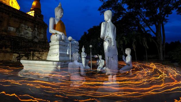Buddhists carry candles as they pray during Vesak Day, an annual celebration of Buddha's birth, enlightenment and death, at Wat Yai Chai Mongkhon temple in Ayutthaya, Thailand,. (Athit Perawongmetha / REUTERS)