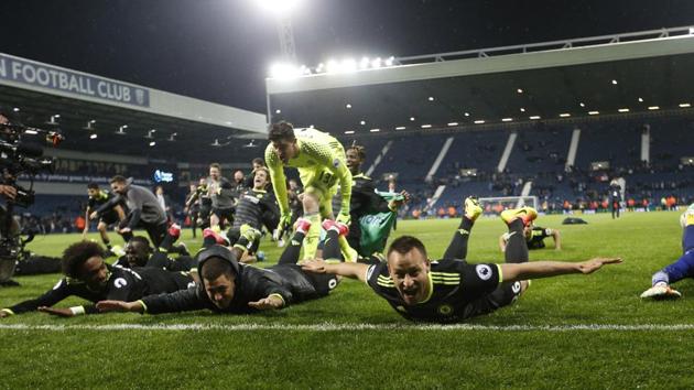 No pool to splash, no problem: Chelsea players celebrate their Premier League title triumph with a slide and dive on the Hawthorns pitch on Friday. (REUTERS)