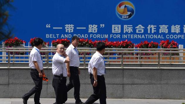 Officials walk outside the China National Convention Center, the venue for the upcoming Belt and Road Forum for International Cooperation, in Beijing. (AFP) Officials walk outside the China National Convention Center, the venue for the upcoming Belt and Road Forum for International Cooperation, in Beijing. (AFP)