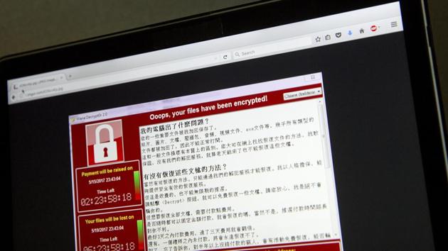A screenshot of the warning screen from a purported ransomware attack, as captured by a computer user in Taiwan, is seen on laptop in Beijing.(AP Photo)