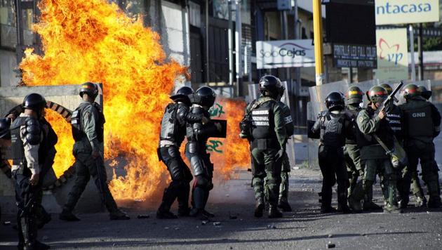 Riot security forces clash with demonstrators during a protest against Venezuela's President Nicolas Maduro's government in Tariba, Venezuela. (Carlos Eduardo /REUTERS)