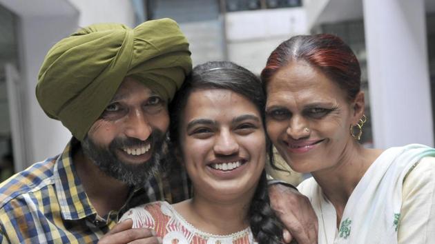 Manpreet Kaur celebrating her success with her parents in Ludhiana on Saturday. (Gurminder Singh/HT)